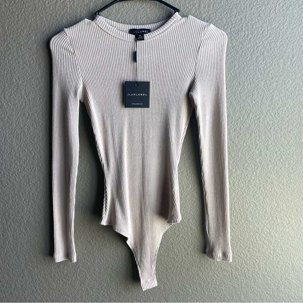 Very flattering bodysuit in Tan. Size medium.